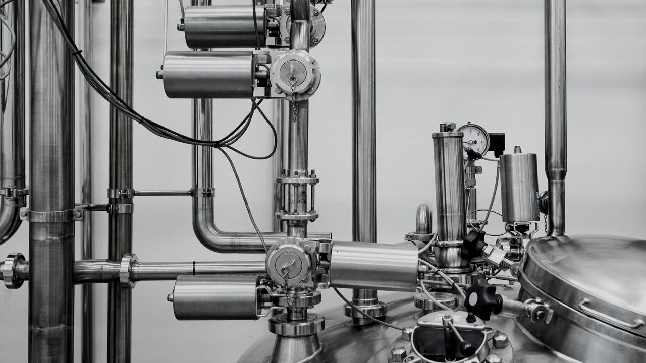 A stainless steel pressure vessel with pneumatic valve actuators